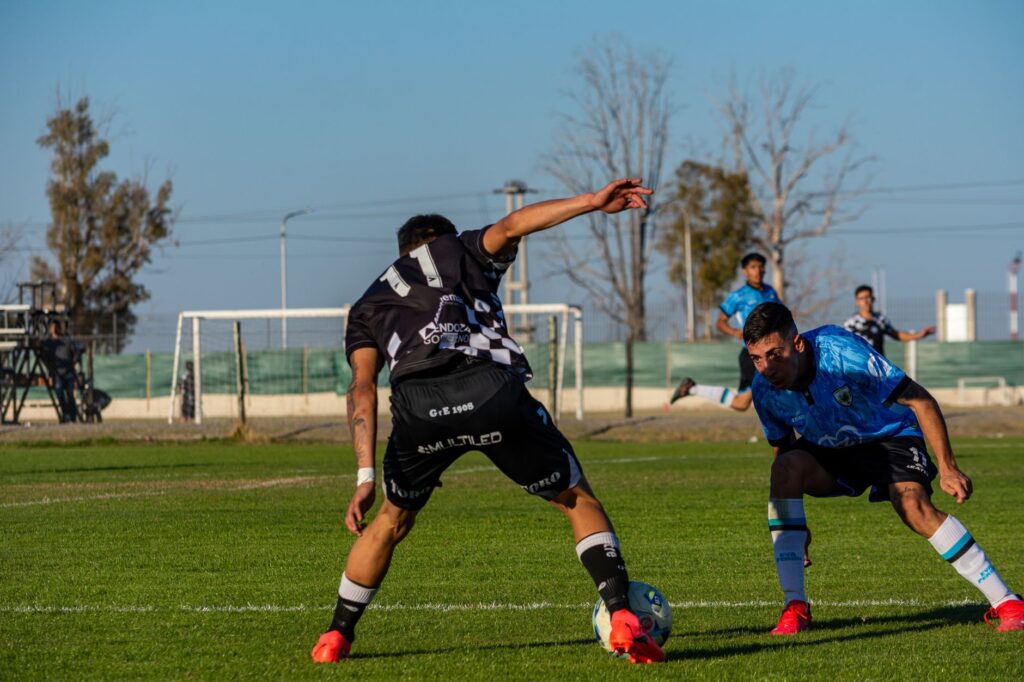 Captured intense moment during a soccer match under clear skies.