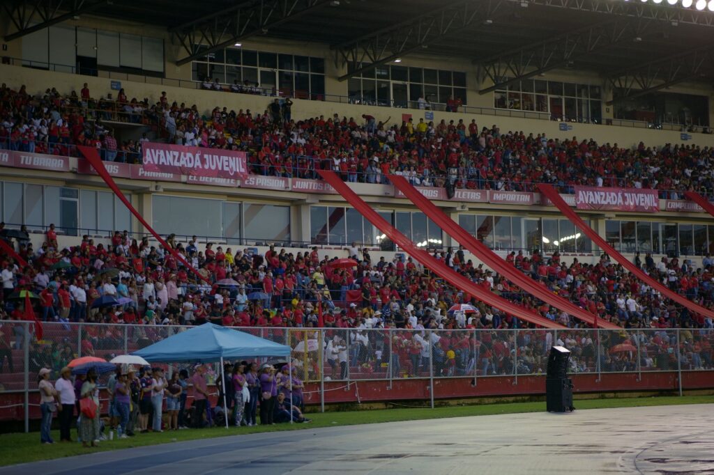 Vibrant scene of an energetic crowd in a stadium, capturing the excitement and enthusiasm of fans in the stands.